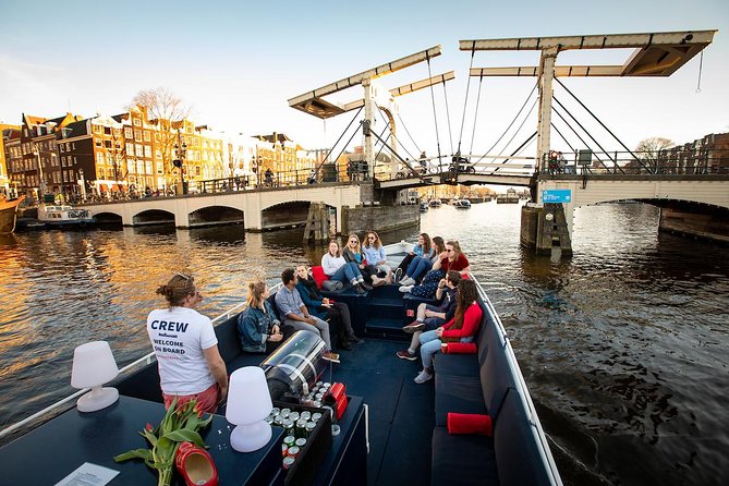 Amsterdam Canal Cruise With Live Guide and Unlimited Drinks - Munt Tower, Rokin, and the western return