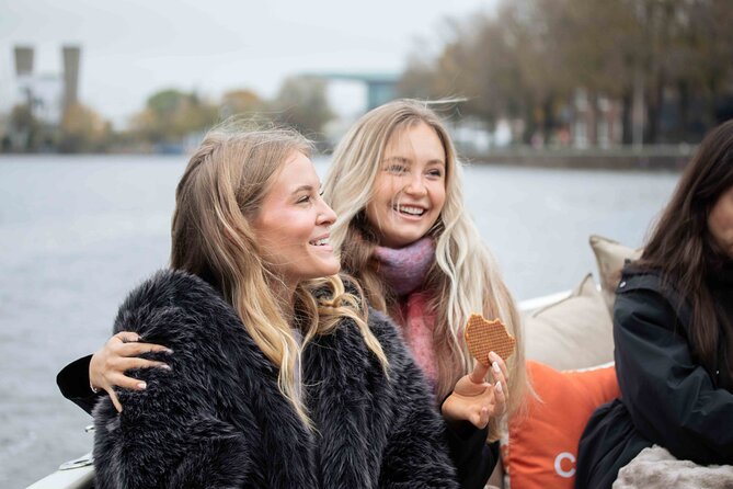 Amsterdam: Luxury Saloon Boat Cruise with Cocktails & Waffle - The guides make the short trip work