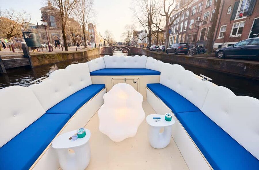 Amsterdam: Smoke & Cruise on covered Cannabis Boat With Bar - The first stretch through the Red Light District