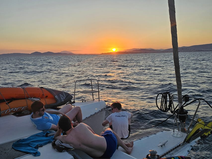 Athens: Riviera Catamaran Tour with Fresh Meal and Drinks - What the crew adds to the day