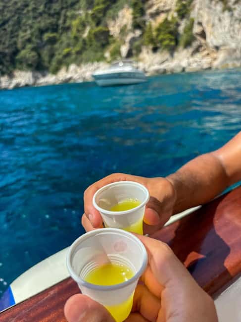 Capri: Scenic Boat Tour with Swimming, Limoncello & Snack - Limoncello, snacks, and the boat itself