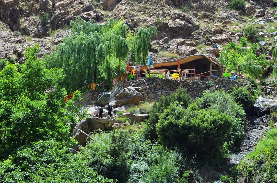 Day Trip To Ouzoud Waterfalls & Boat Ride From Marrakech - A wooden boat under the falls