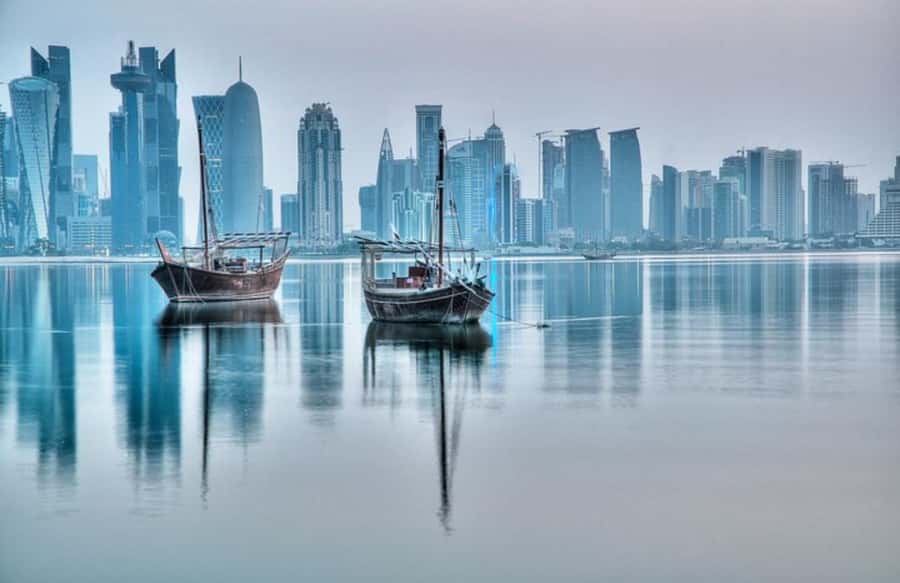 Doha: Sunset Experience, Traditional Dhow Cruise with Dinner - Doha’s skyline from a wooden dhow