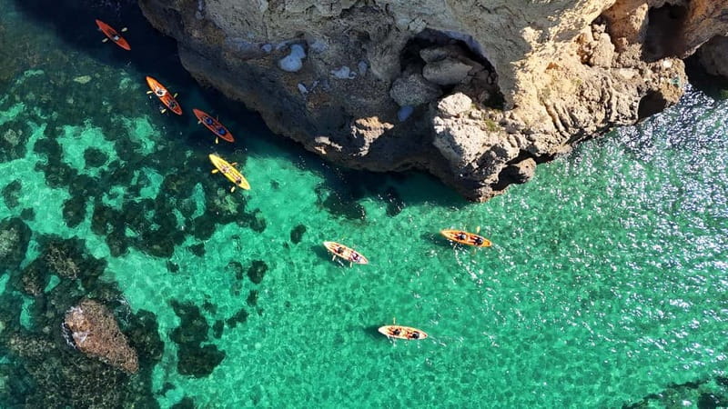 From Lagos: Ponta da Piedade Caves Kayak Tour from Catamaran - Sliding into the kayak