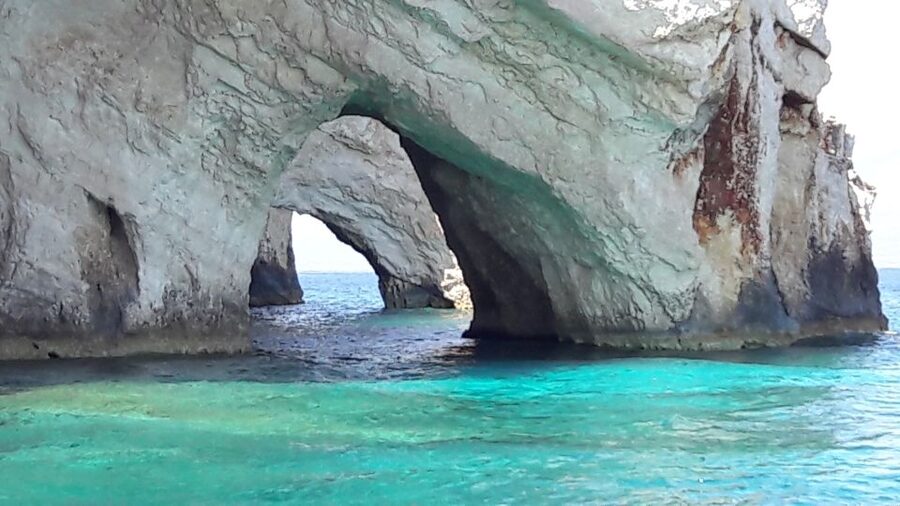 From St.Nikolaos: Boat Cruise to Navagio Beach & Blue Caves - The Blue Caves and that electric blue water