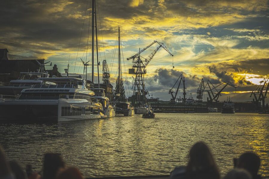 Gdańsk: Sunset Cruise on a Historic Polish Boat - Sunset among cranes, docks, and specialist vessels