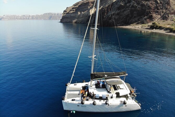 Half-Day Exclusive Catamaran Cruise in Santorini with Meal and Open Bar - Red Beach and the volcanic southern coast