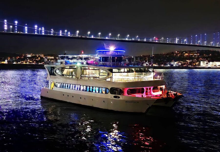 Istanbul: Bosphorus Cruise with Dinner Show - Dinner with Istanbul lights outside the window