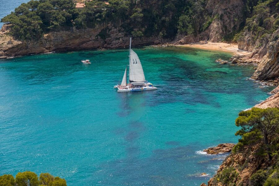Lloret de Mar: Catamaran Sailing Cruise with BBQ and Drinks - The first hour: cliffs, coves, and Costa Brava views