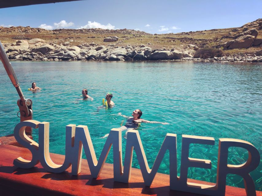 Mykonos: Delos and Rhenia Islands Cruise with BBQ Meal - Rhenia: swimming, snorkeling, and lunch