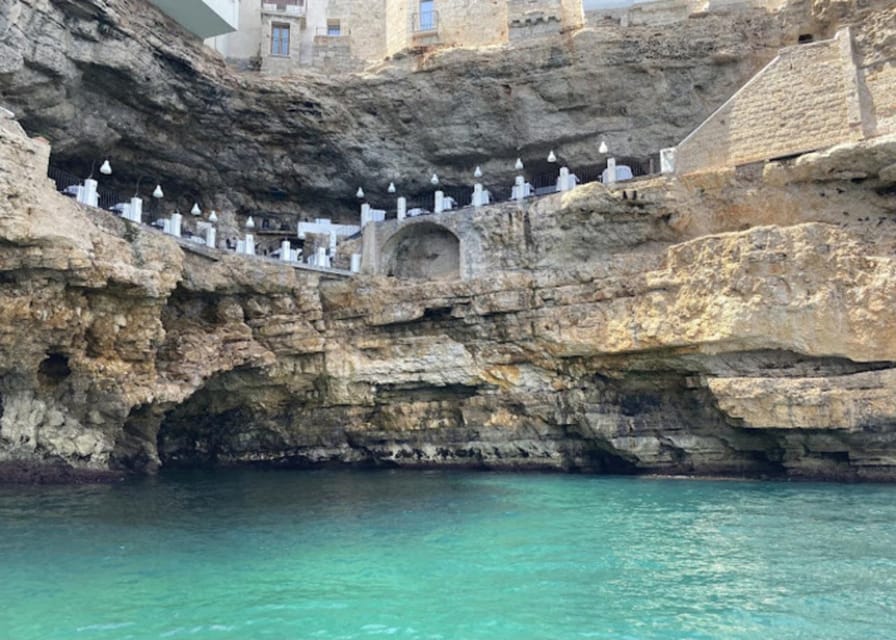Polignano's coast and caves: a boat tour with drinks, swimming, music, and fun - The first coastal sights: monastery, cliffs, and blue water