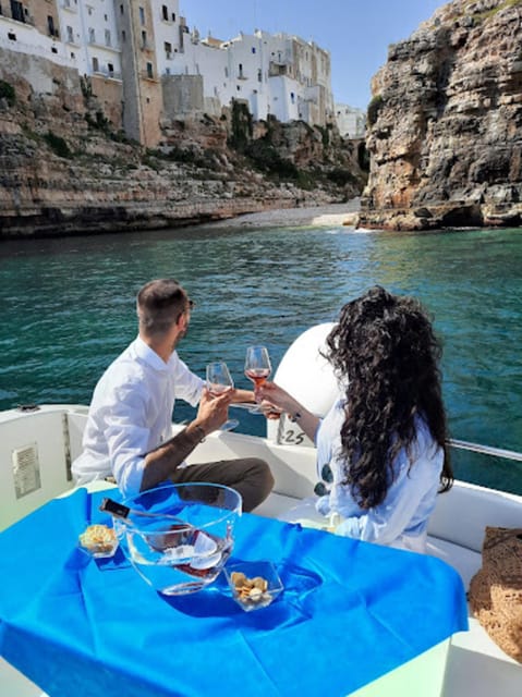 Polignano's coast and caves: a boat tour with drinks, swimming, music, and fun - Lama Monachile and Polignano’s famous cliff view