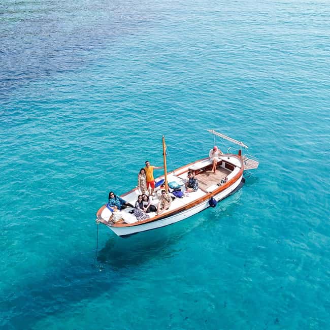 Porto San Paolo: Half Day Boat Tour to Tavolara and Molara - Leaving Porto San Paolo on a classic boat