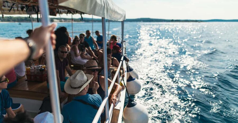 Rovinj: Sunset Cruise with Swim Stop, Drinks, and Fruits - Leaving the harbor and seeing Rovinj from offshore