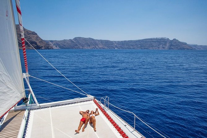 Sailing Catamaran Cruise in Santorini with BBQ, Drinks and Transfer - White Beach, swimming, and the onboard BBQ