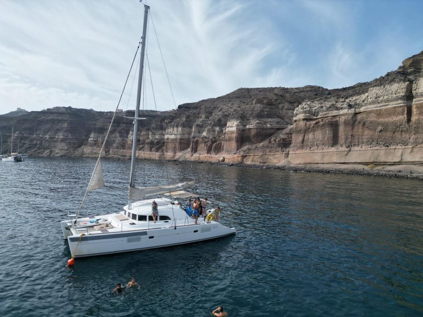 Santorini: Catamaran Cruise with Greek BBQ and Drinks - Sunset, weather, and timing