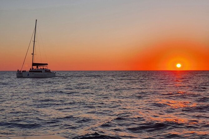 Santorini Classic Catamaran Cruise with BBQ, Drinks and Transfers - Leaving Vlychada for Santorini’s volcanic coast