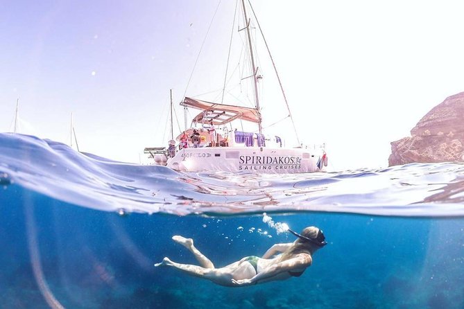 Santorini Classic Catamaran Cruise with BBQ, Drinks and Transfers - Indian Rocks, the lighthouse, and the caldera edge