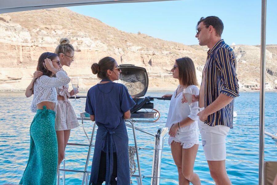 Santorini Gold Catamaran Cruise with Snorkel, BBQ & Open Bar - Sunset from the catamaran