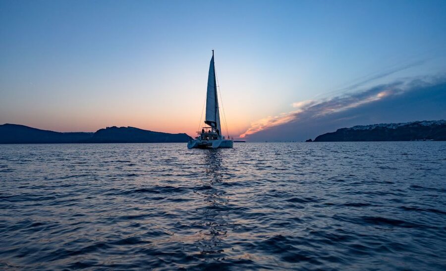 Santorini: Sunset Cruise with Swim Stops, Dinner, and Drinks - What the crew adds to the experience