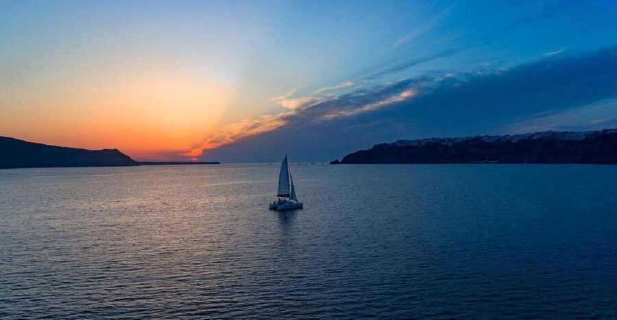 Santorini: Sunset Cruise with Swim Stops, Dinner, and Drinks - Red Beach and Santorini’s volcanic colors