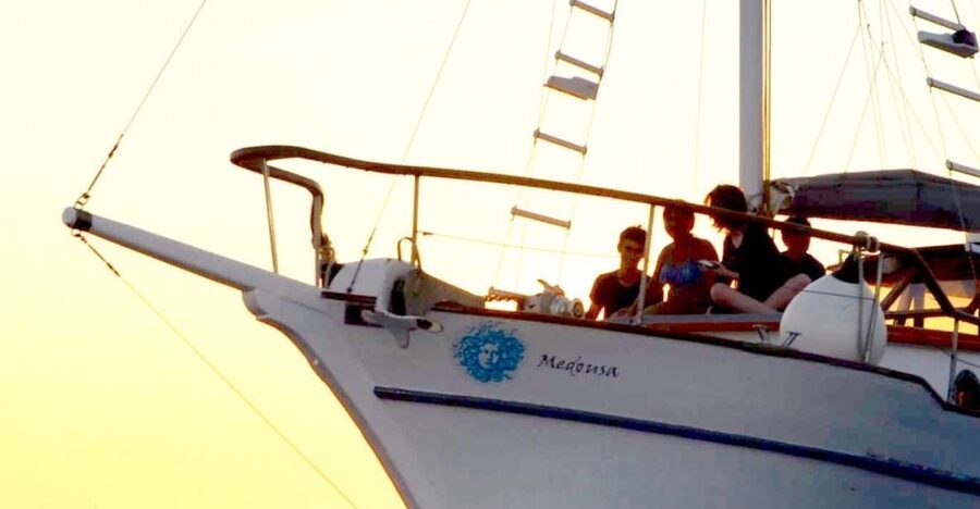 Santorini: Traditional Wooden Boat Tour with Meal and Wine - Entering the caldera by Akrotiri Lighthouse
