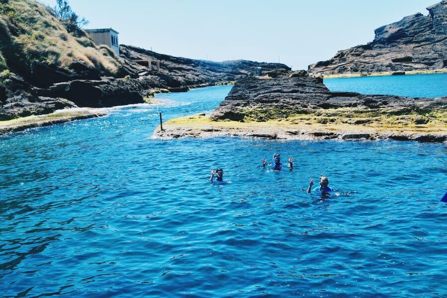 São Miguel: Glass Bottom Boat Tour with Snorkeling - Entering the water for the snorkeling session