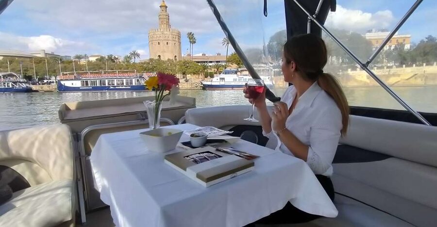 Seville: Exclusive River Boat Tour with Tapas - A gentle start beneath Triana Bridge
