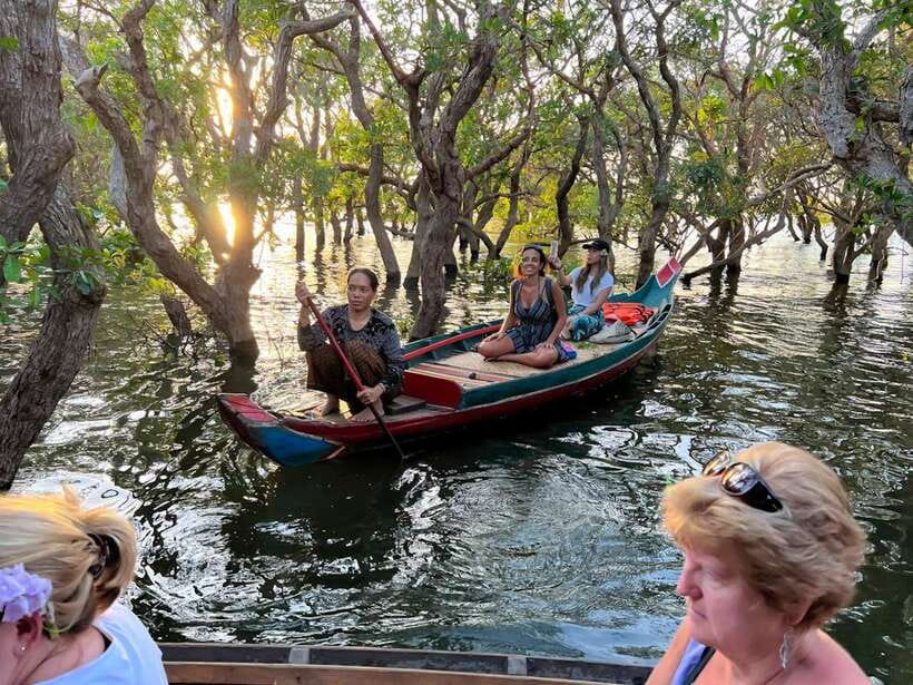Siem Reap Floating Village Kampong Phluk Sunset with Boat - The village boat and the changing water