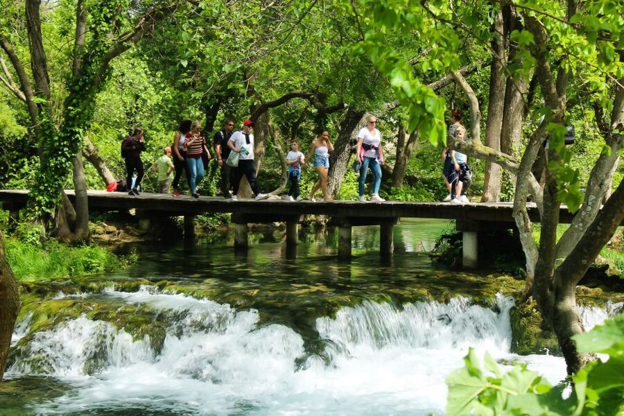 Split: Krka Waterfalls With Boat Cruise, Wine and Olive Oil - Walking the wooden paths at Skradinski buk
