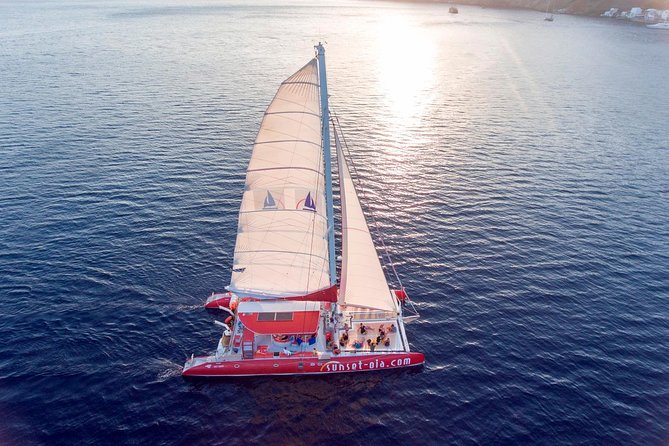 Sunset Sailing Catamaran Cruise in Santorini with BBQ and Drinks - Red Beach from the water